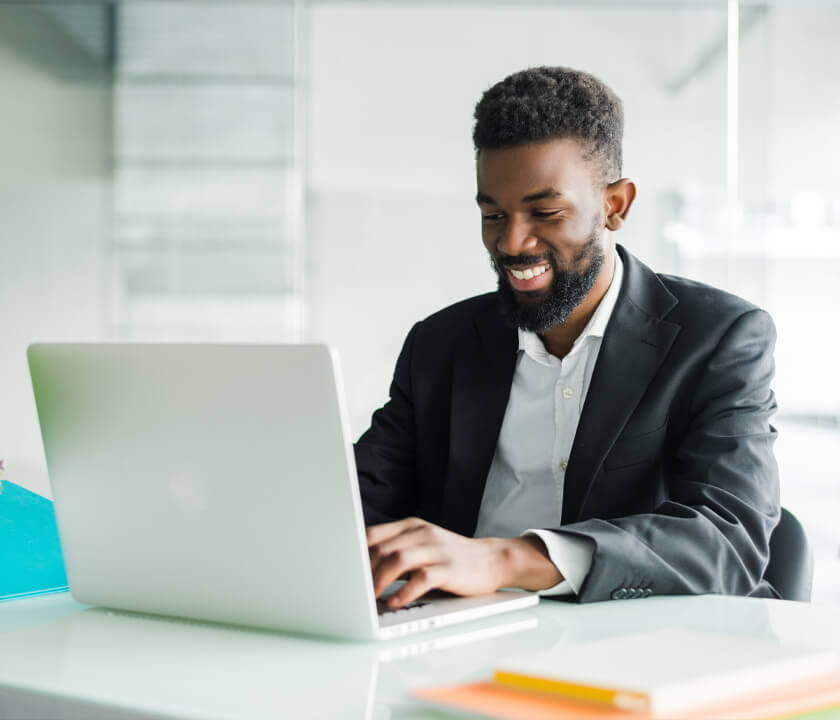Fintech employee using laptop to train on cybersecurity for tech companies