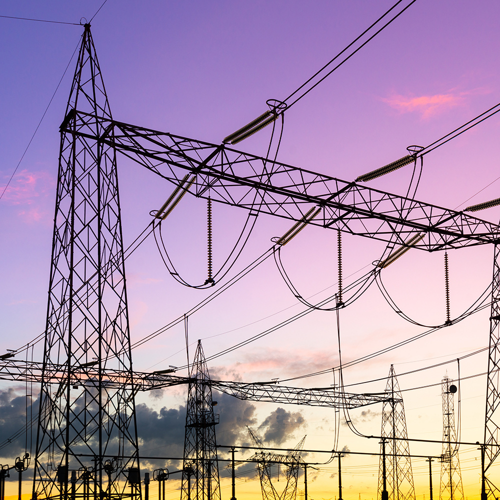 Industrial power lines with purple and orange sunset